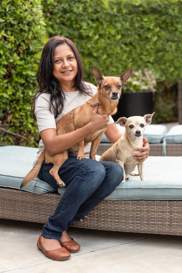 Image of Hetal Sheth (Founder of Curry n Pepper) holding her 2 dogs